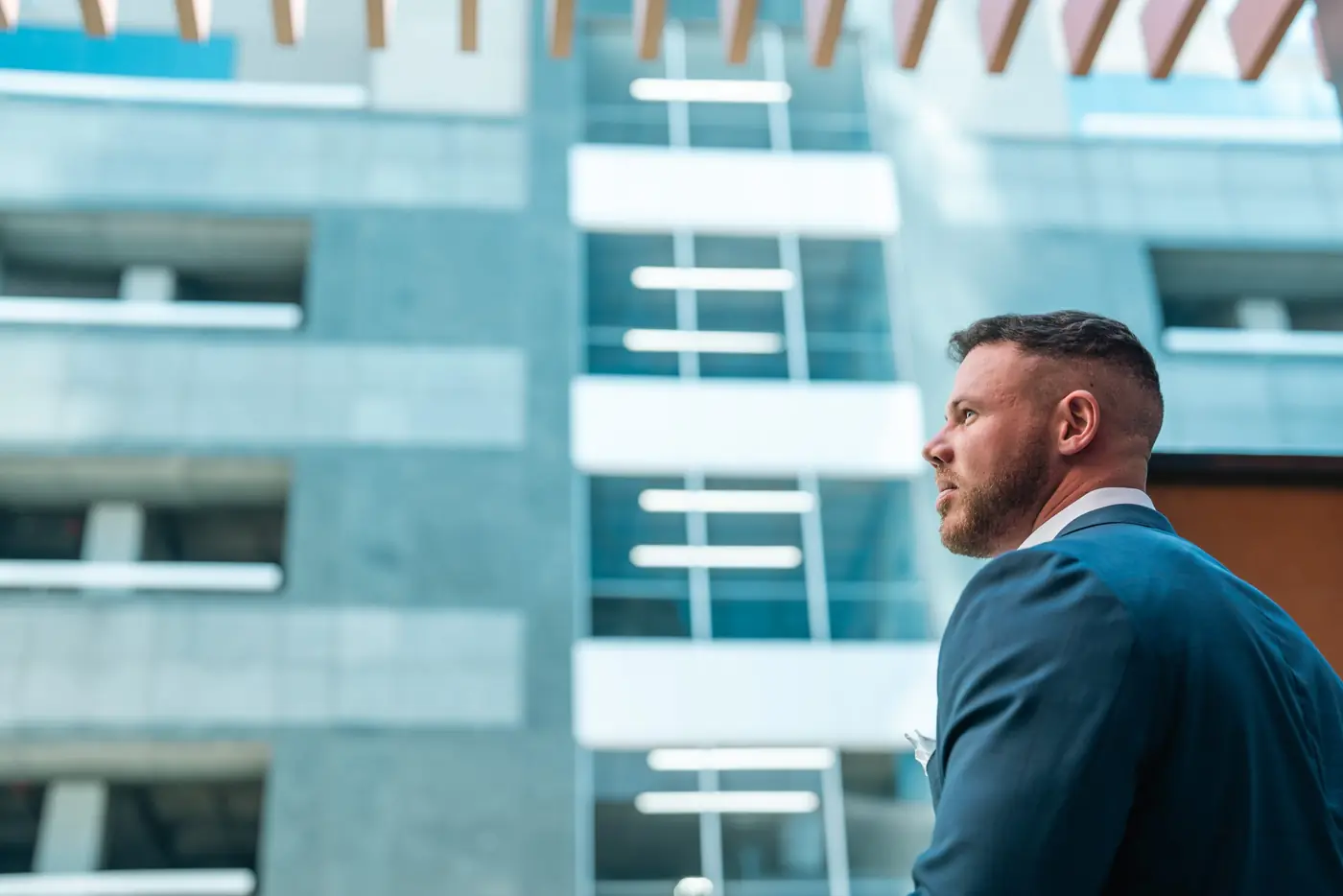 Jake Claver in profile outside a glass office building