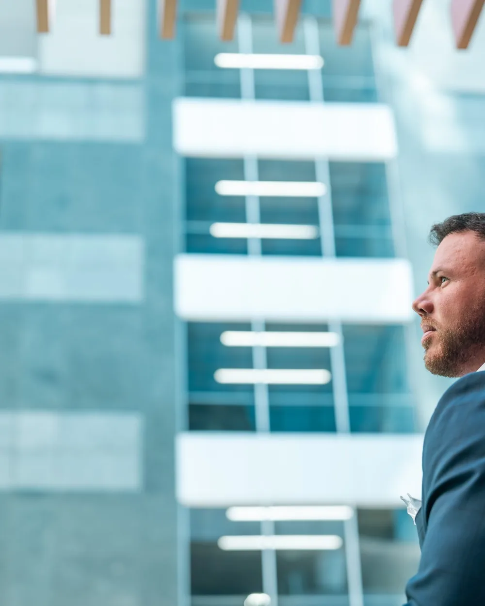 Jake Claver in profile outside a glass office building