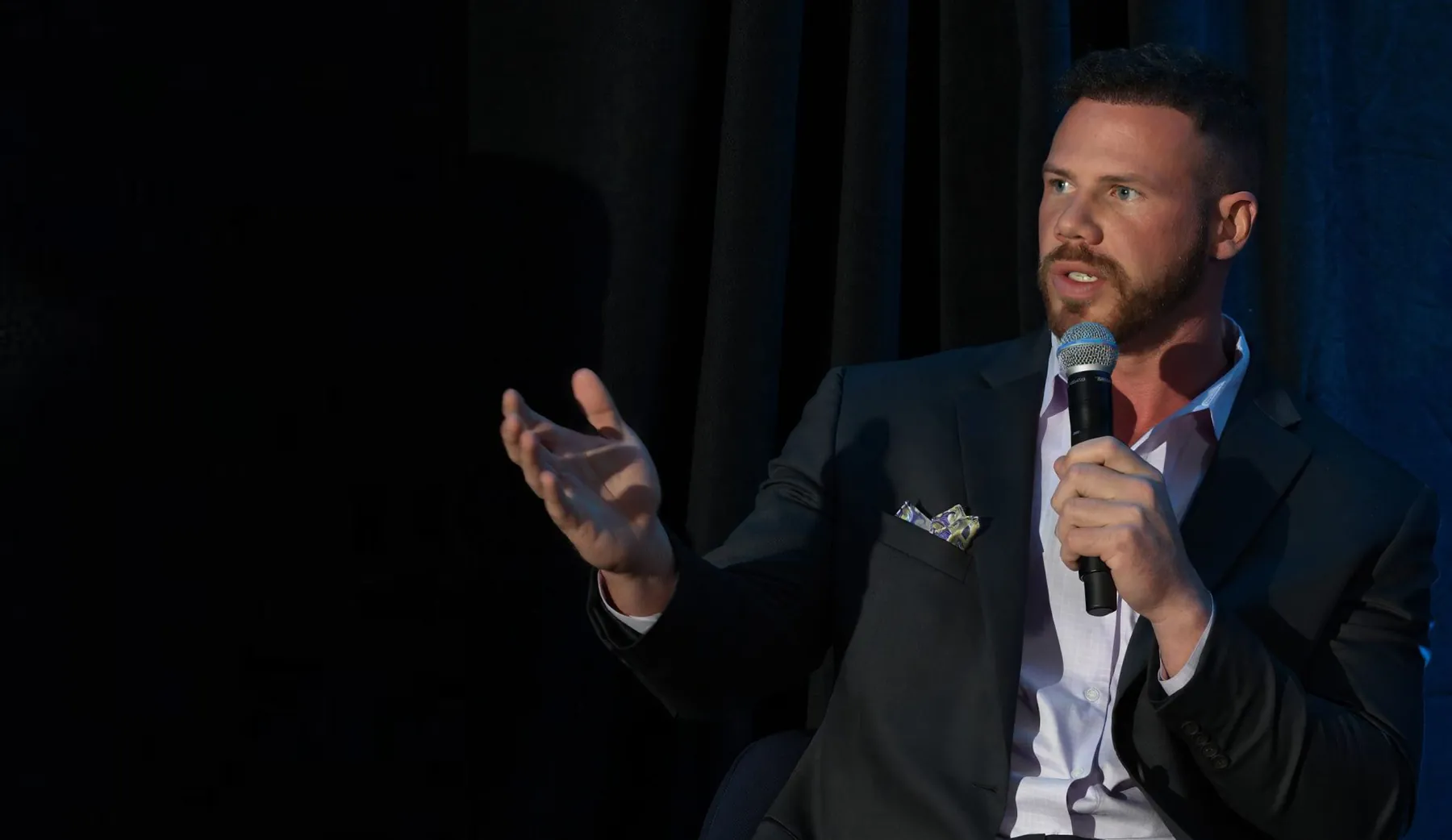 Jake Claver speaking on stage at the Digital Fusion Summit